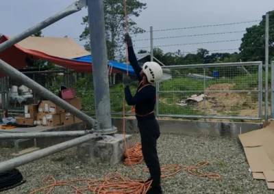 Worker working beside a telecom tower support