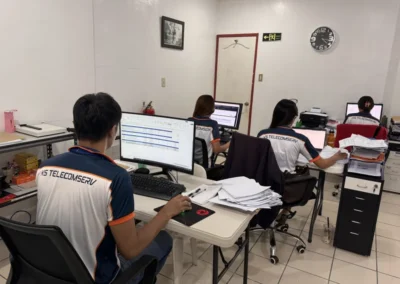 KS Telecomserv staff working at computers in the office
