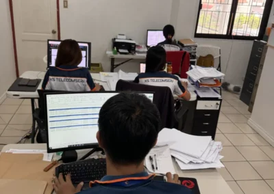 KS Telecomserv staff working at desks in the office