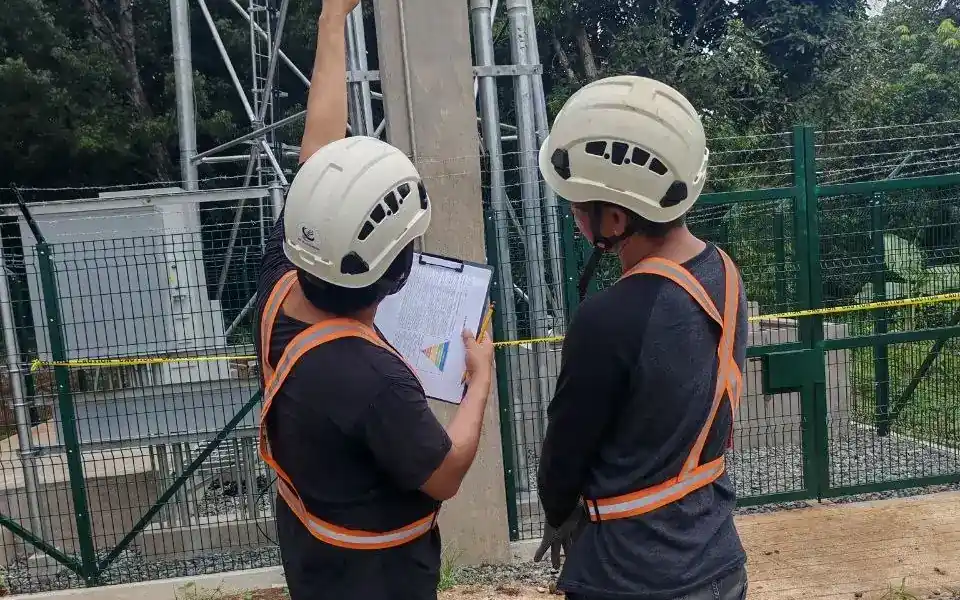 ks-survey-checklist-wide KS Telecomserv supervisors checking site records against the tower installation